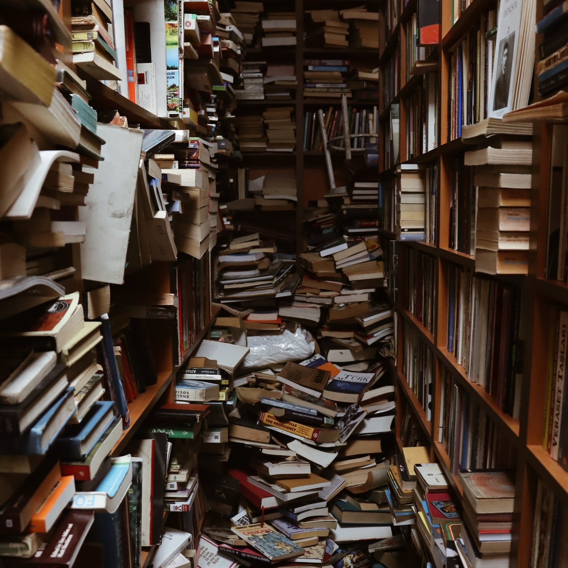 A room full of messy bookcases.