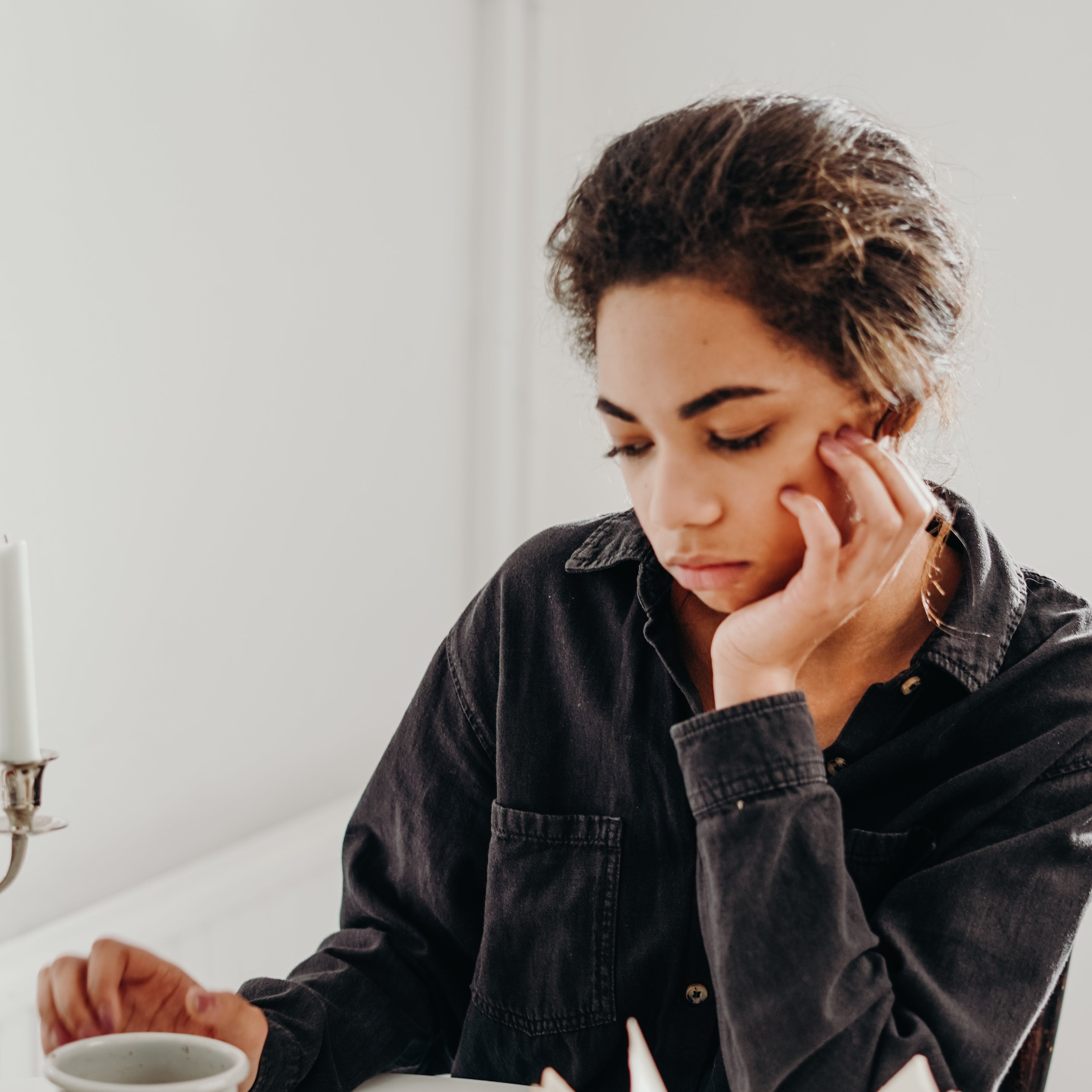 A woman thinking and staring down..