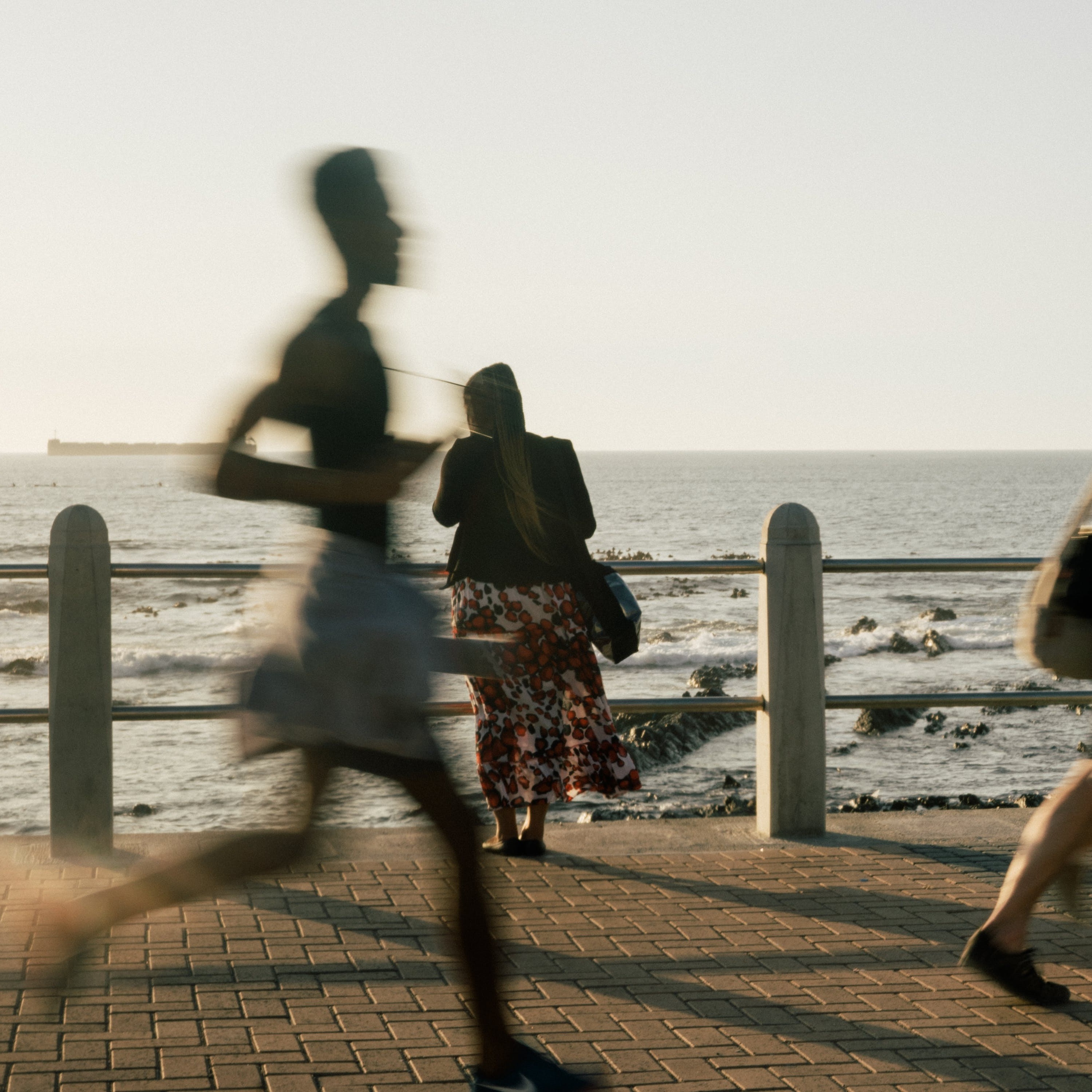 A blurry image of someone running.