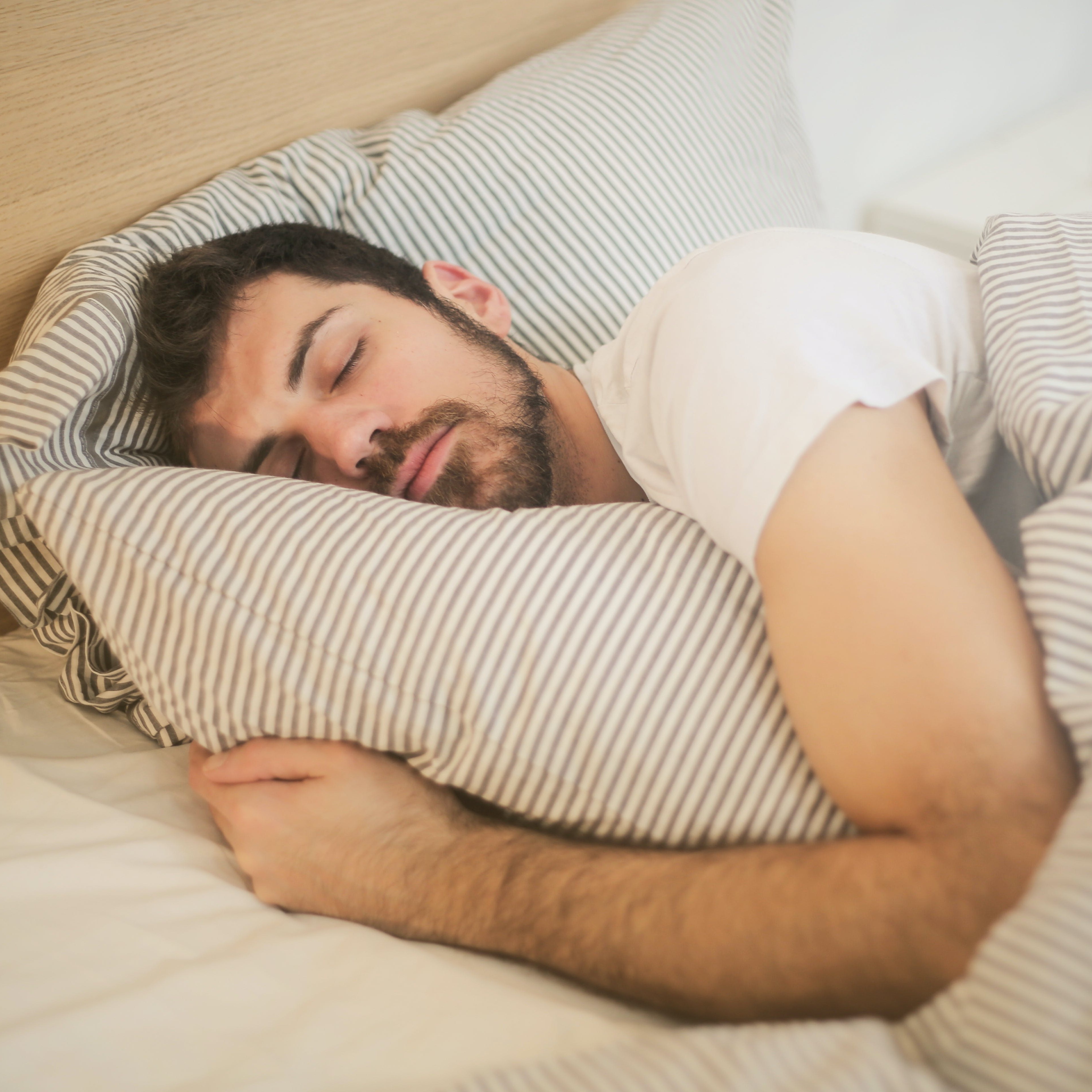 A man sleeping on his pillow.